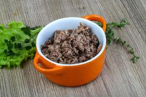 Canned tuna in a bowl on wooden background photo