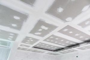 ceiling gypsum board installation at construction site photo