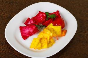 Pickled cabbage on the plate and wooden background photo