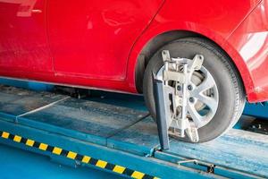 Car wheel alignment in progress at auto repair service centre photo