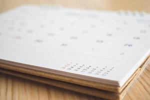 calendar page on wood table background photo