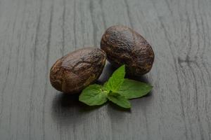 Nutmeg on wooden background photo