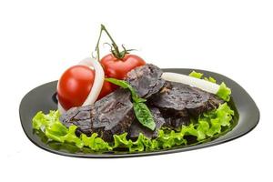 Horsemeat sausage in a bowl on white background photo