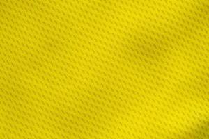 Yellow color sports clothing fabric jersey football shirt texture top view close up photo