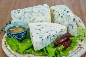 Blue cheese on wooden board and wooden background photo