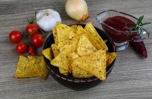 Nachos in a bowl on wooden background photo