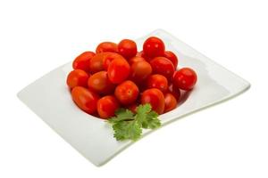 Cherry tomatoes in a bowl on white background photo