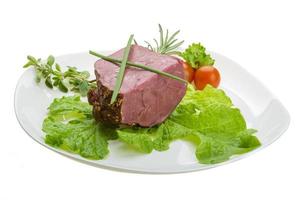 Smoked beef on the plate and white background photo