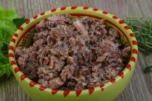 Canned tuna in a bowl on wooden background photo