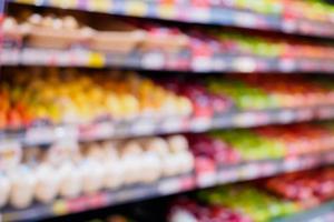 Fresh organic fruits on shelf in supermarket abstract blur background photo