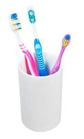 three toothbrushes in ceramic glass photo