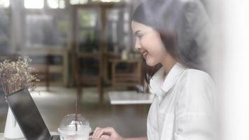 A young woman working with laptop computer in cafe photo