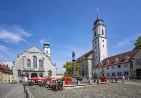 Lindau, Germany - July 21, 2019. The square old town with authentic traditional house tower from church and paving stones. Picturesque panorama landscape landmark. photo