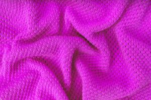 Bright purple knitwear wool fabric texture background. Abstract textile backdrop photo