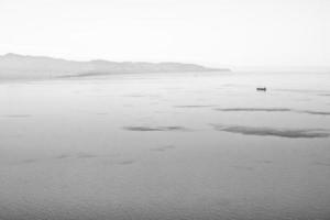 maritime coast of the Tyrrhenian Sea with merchant ship, travel reportage in southern Italy, Calabria photo