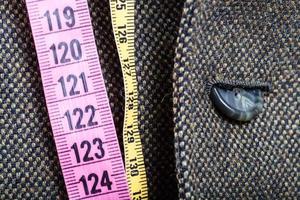 measuring tapes and half buttoned button on jacket photo