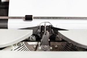 typebar hits ink ribbon in mechanical typewriter photo