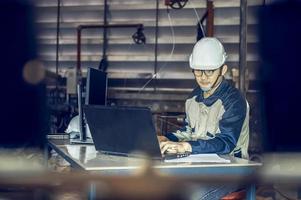 Asian project engineers who control production line facilities Use computers with AI screens, enhanced machine learning assembly processes. photo