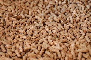 close up to Wood Pellet pile for alternative energy power, raw material background. photo