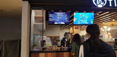 Jakarta, Indonesia in April 2022. Visitors to a cafe are waiting for their orders to be made. This cafe sells a variety of coffee drinks, chocolate and others photo