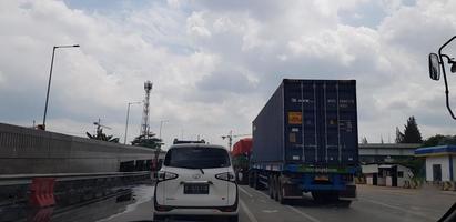 Jakarta, Indonesia in August 2019. Rear view photo of a car and box truck that are in a toll road jam.