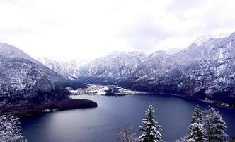 Scenery of Hallstatt Winter snow mountain landscape valley and lake through the forest photo