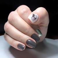 Manicure of different colors on nails. Female manicure on the hand photo