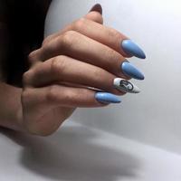 blue female manicure on nails close up photo