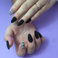 Woman with stylish black manicure on background, closeup photo