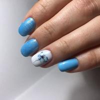 Blue manicure on the nails. Female manicure on the hand photo