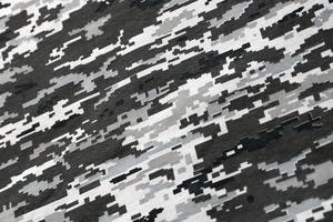 Fabric with texture of Ukrainian military pixeled camouflage. Cloth with camo pattern in grey, brown and green pixel shapes. Official uniform of Ukrainian soldiers photo