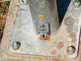 Power pole support. Fastening the base of the support with bolts. photo