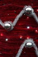 Texture of the wall decorated with New Year's fluffy ribbons and decorations in the form of glossy balls photo