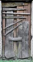 Boarded up wooden door to an old abandoned house photo