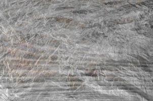 Texture of cellophane material with many folds and bends photo