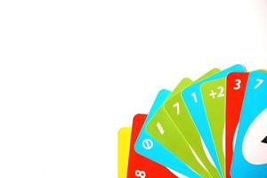 TERNOPIL, UKRAINE - MAY 15, 2022 Many colorful UNO game cards on white background. UNO is an American shedding-type card game that is played with a specially printed deck photo