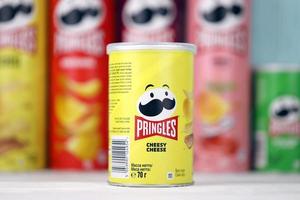 KHARKIV, UKRAINE - DECEMBER 16, 2021 Pringles product with new logo. Pringles is a brand of potato snack chips owned by the Kellogg Company photo