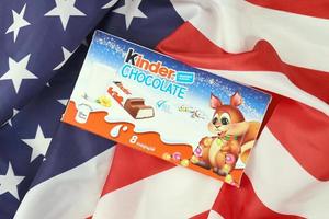 KHARKIV, UKRAINE - DECEMBER 16, 2021 Kinder Chocolate is a children dessert snack made by Italian confectionery brand Ferrero S.p.A. photo