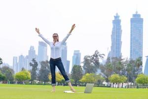 woman with laptop in park photo