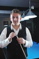 young man play pro billiard game photo