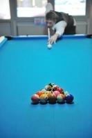 young man play pro billiard game photo