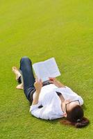 Young woman reading a book in the park photo