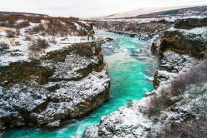 Hraunfossar, a waterfall formed by rivulets streaming over Hallmundarhraun, a lava field from volcano lying under the glacier Langjokull, and pour into the Hvita river, Iceland photo