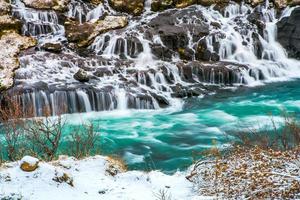 Hraunfossar, a waterfall formed by rivulets streaming over Hallmundarhraun, a lava field from volcano lying under the glacier Langjokull, and pour into the Hvita river, Iceland photo