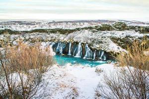Hraunfossar, a waterfall formed by rivulets streaming over Hallmundarhraun, a lava field from volcano lying under the glacier Langjokull, and pour into the Hvita river, Iceland photo