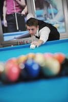 young man play pro billiard game photo