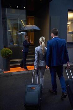 business people couple entering  hotel photo