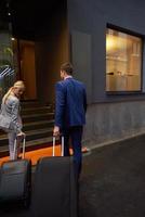 business people couple entering  hotel photo