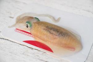 Preparation of raw squid on cutting board. photo