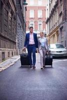 business people couple entering  hotel photo